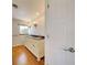 Bathroom with a dual sink vanity, granite countertop, and wood floors at 202 South Dr, Englewood, FL 34223