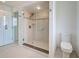 Bathroom features a glass-enclosed shower with tile surround and a grab bar at 202 South Dr, Englewood, FL 34223