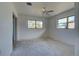 Bright bedroom with dual windows and sliding glass door to patio at 202 South Dr, Englewood, FL 34223