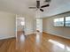 Large bedroom with hardwood floors, ceiling fan, and two closet spaces with doors at 202 South Dr, Englewood, FL 34223