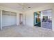 Bright bedroom with sliding glass door to patio and open closet space at 202 South Dr, Englewood, FL 34223