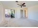 Bright bedroom with sliding glass door to patio and open closet space at 202 South Dr, Englewood, FL 34223
