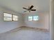 Bright bedroom featuring two windows and a ceiling fan at 202 South Dr, Englewood, FL 34223