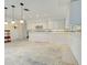 Bright kitchen with white cabinets, mosaic tile accents, and stylish pendant lighting at 202 South Dr, Englewood, FL 34223
