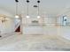 Bright kitchen area with white cabinets and stylish pendant lighting at 202 South Dr, Englewood, FL 34223