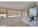 Enclosed lanai with tiled floor, and view to palm trees and the outdoors at 202 South Dr, Englewood, FL 34223