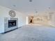 Spacious living room with a decorative fireplace and open access to the kitchen at 202 South Dr, Englewood, FL 34223