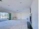 An open-concept living area with a fireplace and sliding glass doors that lead to an outdoor entertainment space at 202 South Dr, Englewood, FL 34223
