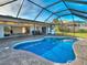 Inviting pool with screened enclosure surrounded by a paved patio, perfect for outdoor relaxation and entertainment at 202 South Dr, Englewood, FL 34223