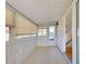 Enclosed sunroom with tile flooring, paneled walls, and several windows letting in natural light at 202 South Dr, Englewood, FL 34223