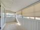 Bright sunroom featuring tile floors, paneled walls, and multiple windows with roller shades at 202 South Dr, Englewood, FL 34223