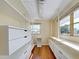 Spacious walk-in closet with custom shelving, drawers, and natural light from multiple windows at 202 South Dr, Englewood, FL 34223