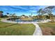 Breathtaking view of circular canal surrounded by grass, docks, tropical trees, and lush landscaping at 202 South Dr, Englewood, FL 34223