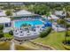 Beautiful aerial view of the community pool, dining areas, and lush landscaping within the community at 220 Southampton Drive # 325, Venice, FL 34293