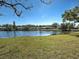 Expansive backyard with a tranquil pond view and lush green space, great for outdoor activities at 220 Southampton Drive # 325, Venice, FL 34293