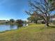 Scenic backyard featuring a serene pond and lush greenery at 220 Southampton Drive # 325, Venice, FL 34293