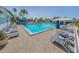 Large community pool with lounge chairs and palm trees, perfect for relaxation and recreation at 220 Southampton Drive # 325, Venice, FL 34293