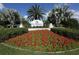 Community sign surrounded by a vibrant flower bed and lush green landscaping at 220 Southampton Drive # 325, Venice, FL 34293