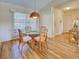 Bright dining room with a glass table, stylish rattan chairs, and natural light from large windows at 220 Southampton Drive # 325, Venice, FL 34293