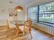 Dining area with rattan chairs, glass table, and large windows bringing in natural light with views outside at 220 Southampton Drive # 325, Venice, FL 34293