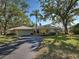 Charming single-story home featuring lush landscaping, a two-car garage, and a welcoming driveway at 220 Southampton Drive # 325, Venice, FL 34293