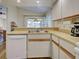 Well-maintained kitchen with laminate countertops and white appliances at 220 Southampton Drive # 325, Venice, FL 34293