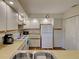 Kitchen view featuring white cabinets and stainless sink at 220 Southampton Drive # 325, Venice, FL 34293