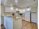 Efficient kitchen with white appliances and laminate countertops at 220 Southampton Drive # 325, Venice, FL 34293