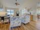 Bright living room with vaulted ceilings, ceiling fan, and coastal-themed decor at 220 Southampton Drive # 325, Venice, FL 34293