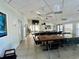 Large meeting room with tables, chairs, and a ceiling fan at 220 Southampton Drive # 325, Venice, FL 34293