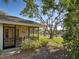 Relaxing screened-in lanai overlooking a serene lake view, surrounded by mature trees and landscaping at 220 Southampton Drive # 325, Venice, FL 34293
