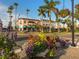 Charming street view with colorful flower beds, tropical palms, and classic architecture in a vibrant downtown area at 220 Southampton Drive # 325, Venice, FL 34293