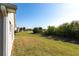 The manicured backyard with lake views and well-maintained lawn at 24135 Buckingham Way, Punta Gorda, FL 33980