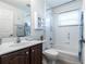 Well-lit bathroom offers a shower-tub combo and a classic vanity at 24135 Buckingham Way, Punta Gorda, FL 33980