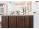 Bathroom featuring a double vanity, framed mirror, and plenty of storage in dark wood cabinetry at 24135 Buckingham Way, Punta Gorda, FL 33980