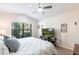 Bedroom featuring an arched window, hardwood floors, and TV at 24135 Buckingham Way, Punta Gorda, FL 33980