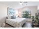 Bedroom featuring an arched window, cool color scheme, hardwood floors, and TV at 24135 Buckingham Way, Punta Gorda, FL 33980