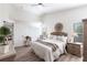 Cozy bedroom with neutral decor, natural light, and hardwood floors for a serene retreat at 24135 Buckingham Way, Punta Gorda, FL 33980