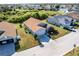 Charming single-story home featuring a well-manicured lawn and an attached two-car garage at 24135 Buckingham Way, Punta Gorda, FL 33980