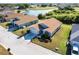 Single-story home featuring a well-manicured lawn and an attached two-car garage, set in a golf community with water view at 24135 Buckingham Way, Punta Gorda, FL 33980