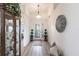 Bright foyer features hardwood floors, decorative accents, and a view of the elegant front door at 24135 Buckingham Way, Punta Gorda, FL 33980