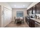 Eat in kitchen features stainless appliances, dark wood cabinets, and a bright window at 24135 Buckingham Way, Punta Gorda, FL 33980