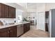 Open kitchen overlooking the dining room offers stainless appliances and neutral countertops at 24135 Buckingham Way, Punta Gorda, FL 33980