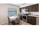 Charming kitchen with wood cabinets, stainless steel appliances, and breakfast table at 24135 Buckingham Way, Punta Gorda, FL 33980