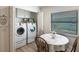 Convenient laundry room features a washer, dryer, and table at 24135 Buckingham Way, Punta Gorda, FL 33980