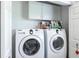 Laundry room featuring a Samsung washer and dryer with overhead storage at 24135 Buckingham Way, Punta Gorda, FL 33980
