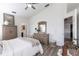 This main bedroom boasts high ceilings, stylish furniture, and access to the bathroom at 24135 Buckingham Way, Punta Gorda, FL 33980