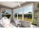 Bright sunroom with large windows and a cozy seating area at 24135 Buckingham Way, Punta Gorda, FL 33980