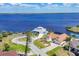 A beautiful aerial view of waterfront homes with water access on a bright sunny day at 2418 Herron Ter, Port Charlotte, FL 33981