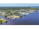Aerial view of two waterfront homes with a dock, lift and pools at 2418 Herron Ter, Port Charlotte, FL 33981